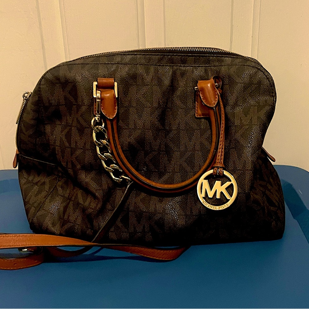 Large brown leather logo Micheal Kors purse.